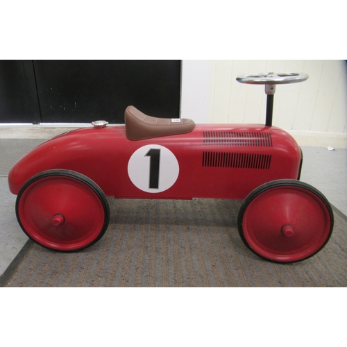 285 - A replica of a vintage red, white and black painted metal ride-on racing car