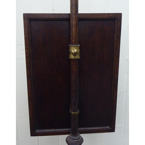 53 - A 1930s oak polescreen, set with a tapesrty panel, raised on a tripod base  56