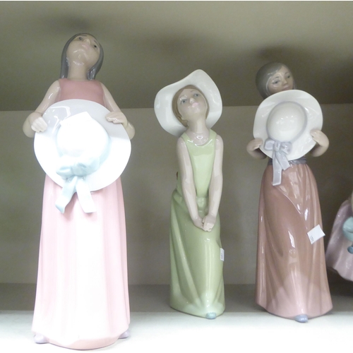 56 - Five Lladro porcelain figures: to include young women, in various poses  tallest 9