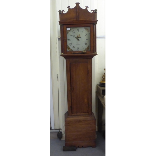 70 - An early 19thC mahogany longcase clock; the bell strike, weight driven movement faced by a painted R... 