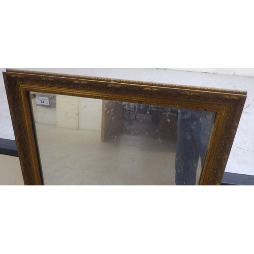 74 - A 20thC mirror, the plate set in a moulded gilt frame  19.5