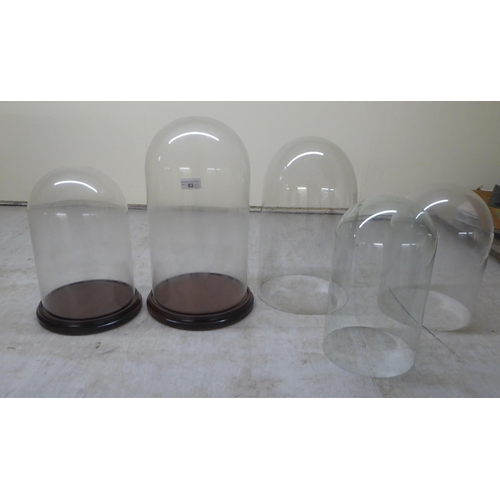 82 - Five glass display domes: to include a pair  12.5