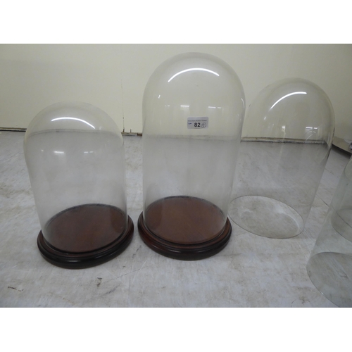 82 - Five glass display domes: to include a pair  12.5