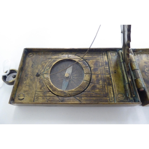 89 - A 20thC brass astronomical compendium, the hinged body enclosing a compass, dials and calendar