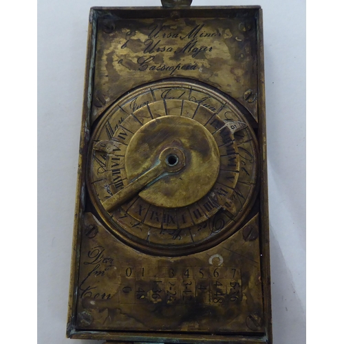 89 - A 20thC brass astronomical compendium, the hinged body enclosing a compass, dials and calendar