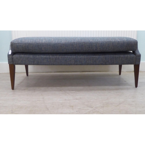 58 - A modern blue fabric upholstered, cushioned, window seat, raised on square, tapered legs  55