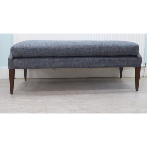 58 - A modern blue fabric upholstered, cushioned, window seat, raised on square, tapered legs  55