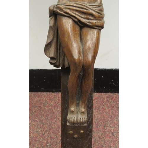 9 - A late 19thC carved oak crucifix, a banner on the cross, inscribed 'RNRI' and inscribed L Verbeke&nb... 