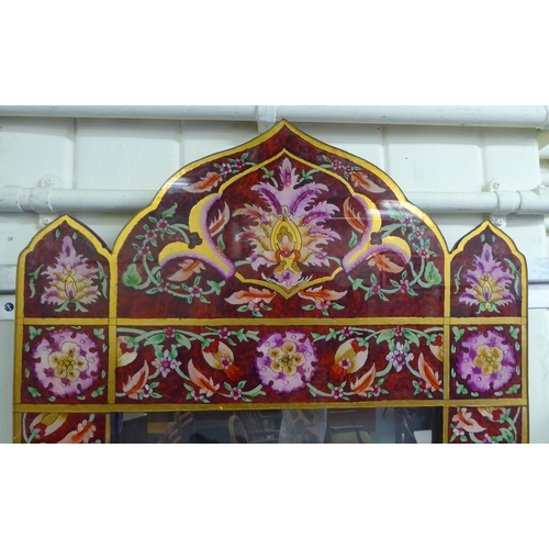 21 - A modern mirror, the plate set in a laminated Asian inspired wooden frame, decorated in bright colou... 
