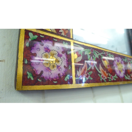 21 - A modern mirror, the plate set in a laminated Asian inspired wooden frame, decorated in bright colou... 