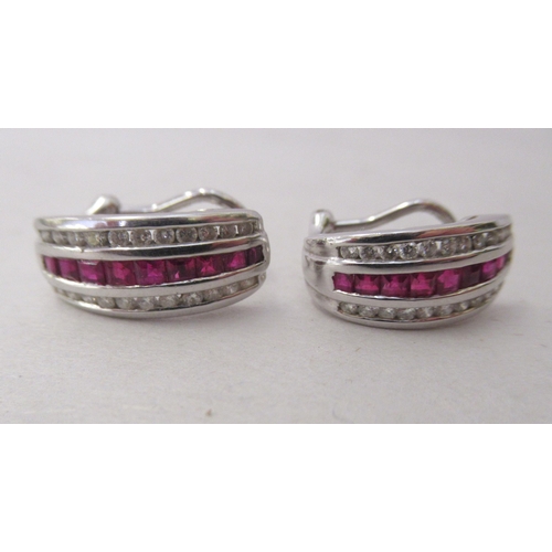 324 - A pair of 14k white gold, ruby and diamond set earrings