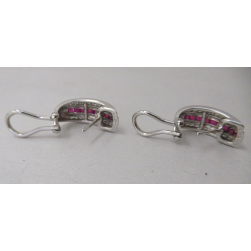 324 - A pair of 14k white gold, ruby and diamond set earrings