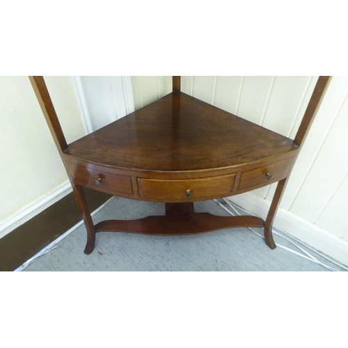 53 - A George III mahogany two tier quadrant washstand, raised on splayed legs  40