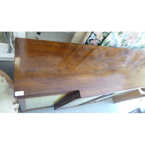 9 - A Regency rosewood and mahogany breakfront sideboard with four glazed doors, raised on bracket feet ... 