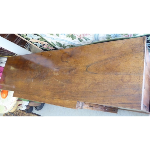 9 - A Regency rosewood and mahogany breakfront sideboard with four glazed doors, raised on bracket feet ... 