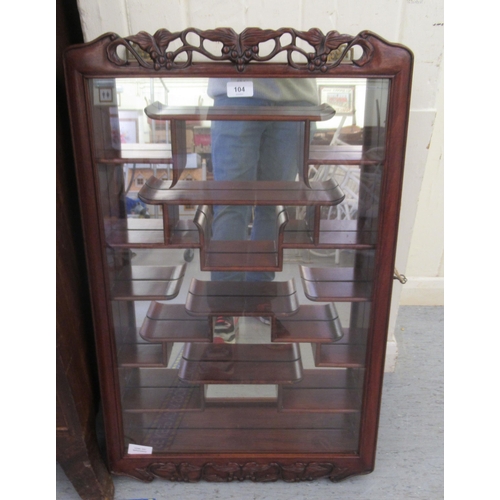 104 - A modern Japanese rosewood netsuke cabinet with a glazed door, enclosing tiered shelves  32