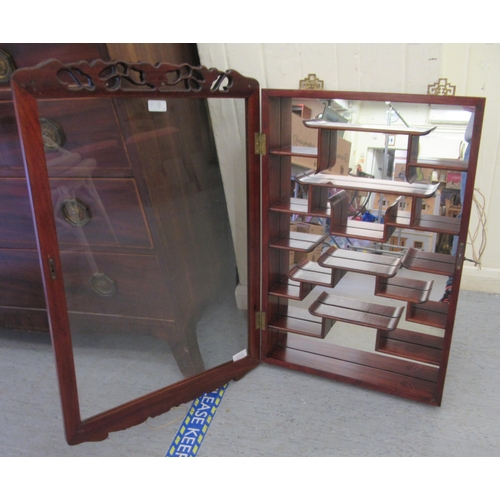 104 - A modern Japanese rosewood netsuke cabinet with a glazed door, enclosing tiered shelves  32