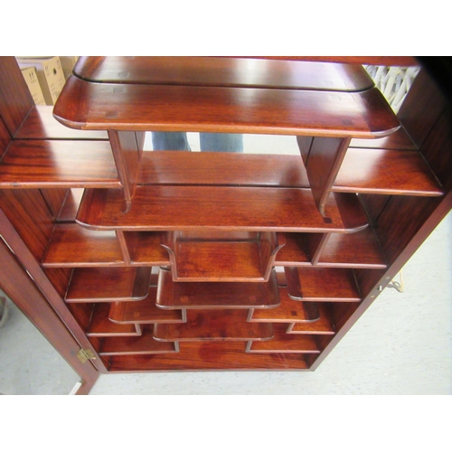 104 - A modern Japanese rosewood netsuke cabinet with a glazed door, enclosing tiered shelves  32