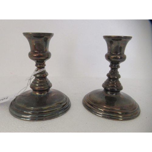 105 - A pair of Sterling silver candlesticks, each on a loaded base  4.5