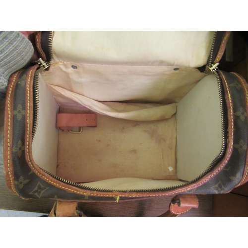 107 - A Louis Vuitton make-up bag with stitched brown hide handles