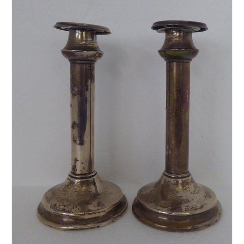 11 - A pair of silver candlesticks, on loaded bases  Chester 1926  7