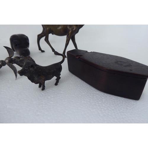 123 - Collectables: to include a 19thC novelty coffin design mahogany snuff box; and a white metal, flexib... 