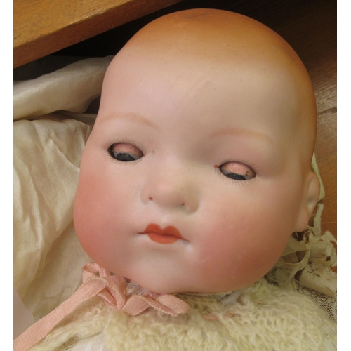 127 - An early 20thC Armand Marseille bisque head doll with painted features and weighted, sleeping eyes, ... 