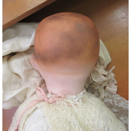 127 - An early 20thC Armand Marseille bisque head doll with painted features and weighted, sleeping eyes, ... 