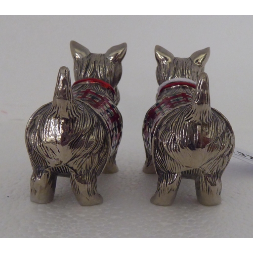 137 - A pair of part enamelled novelty condiments pots, fashioned as Scottie dogs