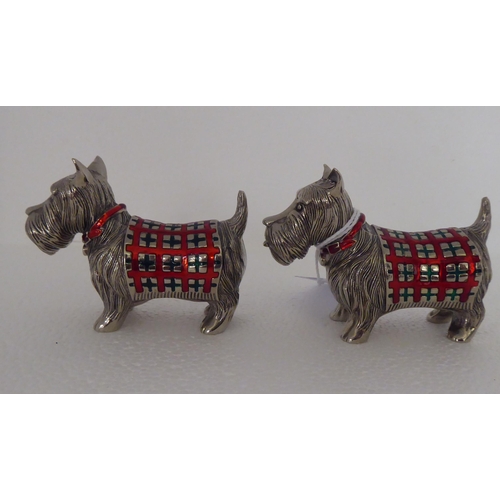 137 - A pair of part enamelled novelty condiments pots, fashioned as Scottie dogs