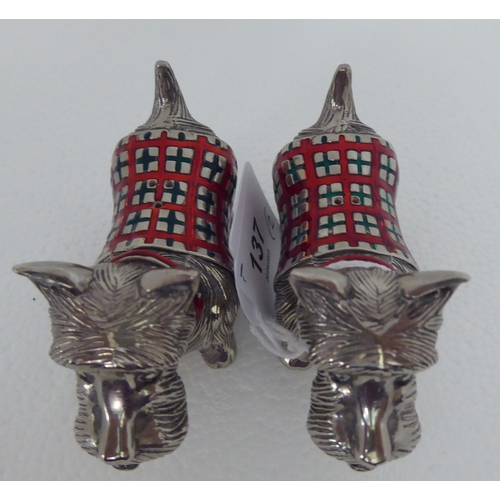 137 - A pair of part enamelled novelty condiments pots, fashioned as Scottie dogs