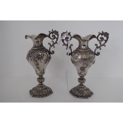 146 - A pair of Continental silver coloured metal miniature, twin handled, ovoid shaped pedestal vases&nbs... 