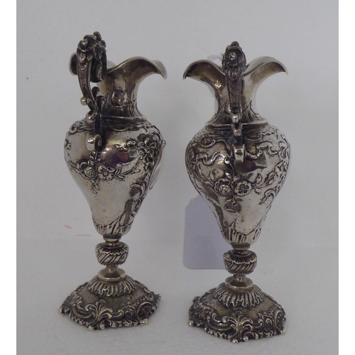 146 - A pair of Continental silver coloured metal miniature, twin handled, ovoid shaped pedestal vases&nbs... 