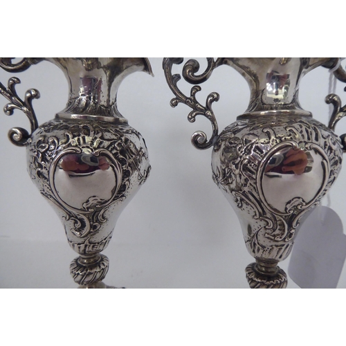 146 - A pair of Continental silver coloured metal miniature, twin handled, ovoid shaped pedestal vases&nbs... 