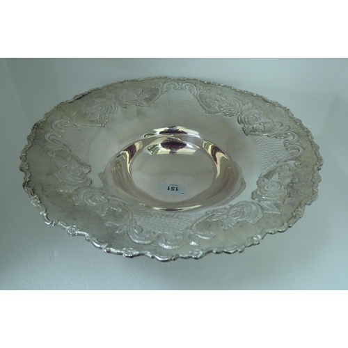 151 - A Continental silver coloured metal fruit dish, the wide, flared, embossed and chased, floral patter... 