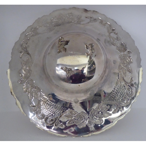 151 - A Continental silver coloured metal fruit dish, the wide, flared, embossed and chased, floral patter... 