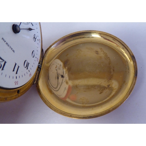 165 - A Waltham 18ct gold cased full hunter pocket watch, the keyless movement faced by a white enamel Ara... 