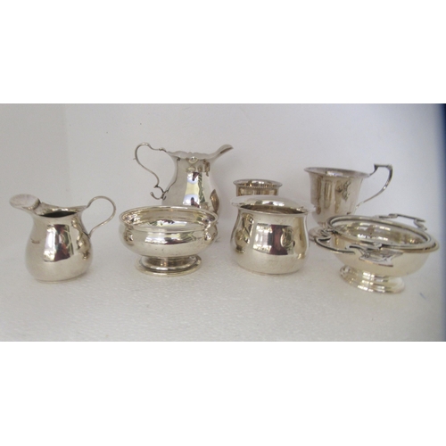 167 - Silver tableware: to include a tea strainer and bowl; a toddy cup; and a cream jug  mixed marks