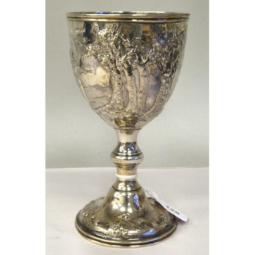 170 - A mid Victorian silver trophy cup of ovoid form, on a knopped pedestal and domed foot, embossed and ... 