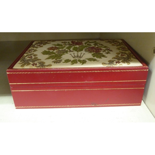 174 - A Rolex tooled and gilded red hide presentation box, the hinged lid set with an embroidered panel, f... 