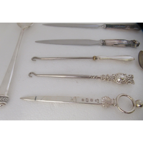 182 - Silver and silver coloured metal items: to include a modern long handled spoon; and three silver han... 