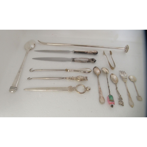 182 - Silver and silver coloured metal items: to include a modern long handled spoon; and three silver han... 