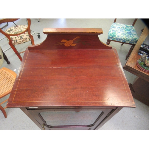 204 - An Edwardian satinwood inlaid mahogany display cabinet with a single glazed and panelled door, raise... 