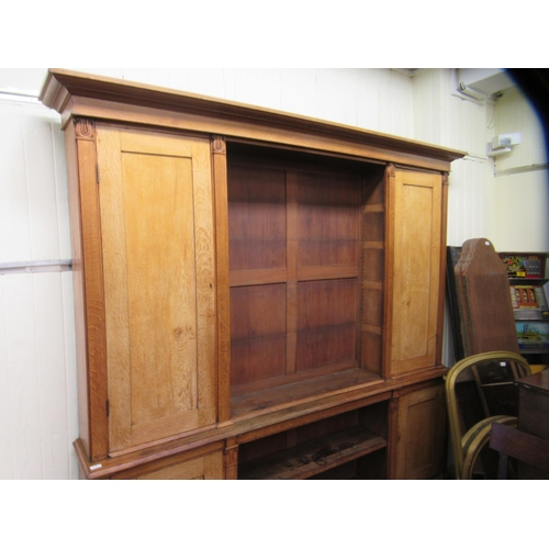 217 - A mid Victorian oak library bookcase, comprising a central section of seven open shelves, flanked by... 