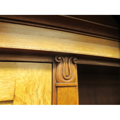 217 - A mid Victorian oak library bookcase, comprising a central section of seven open shelves, flanked by... 