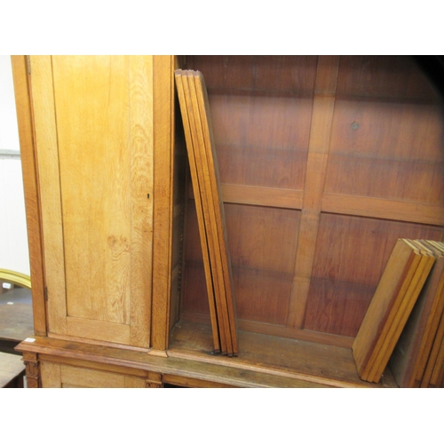 217 - A mid Victorian oak library bookcase, comprising a central section of seven open shelves, flanked by... 