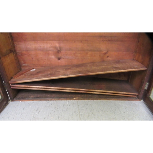 222 - A late Victorian mahogany bookcase, enclosed by two full height astragal glazed doors  70