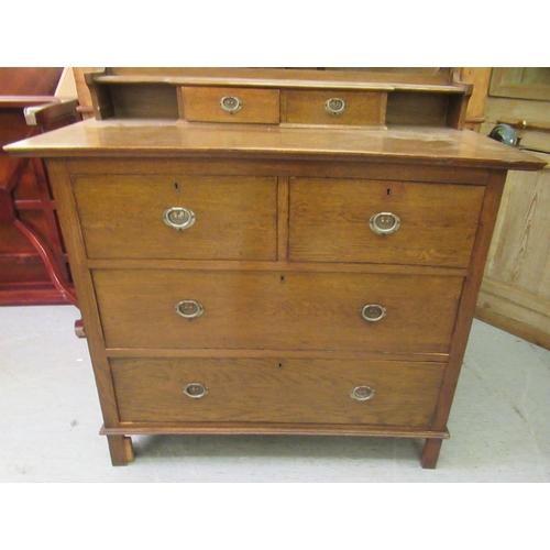 227 - A 1930s Arts & Crafts inspired oak dressing table, the bevelled mirror pivoting on square horns,... 