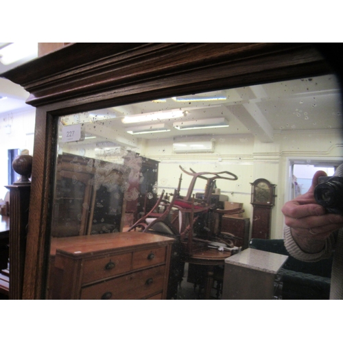 227 - A 1930s Arts & Crafts inspired oak dressing table, the bevelled mirror pivoting on square horns,... 