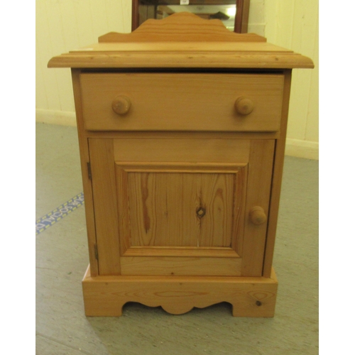 229 - A modern pine bedside cabinet with a drawer and a door, on a plinth  24